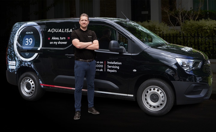 An installer standing in front of an Aqualisa liveried van, with his arms crossed